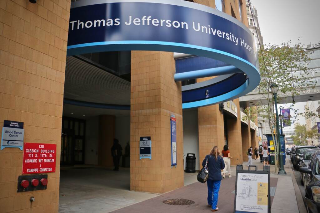 2021 10 04-e lee-philadelphia thomas jefferson university hospital north People walk by the hospital entrance.