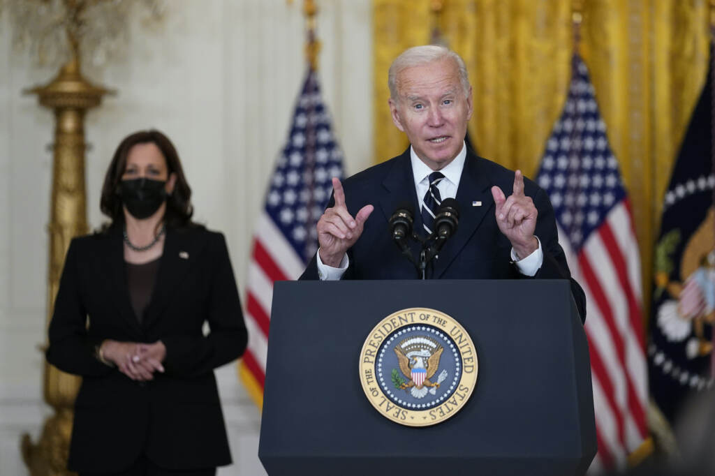 Joe Biden, Kamala Harris President Joe Biden speaks from a podium, with VP Kamala Harris in the background