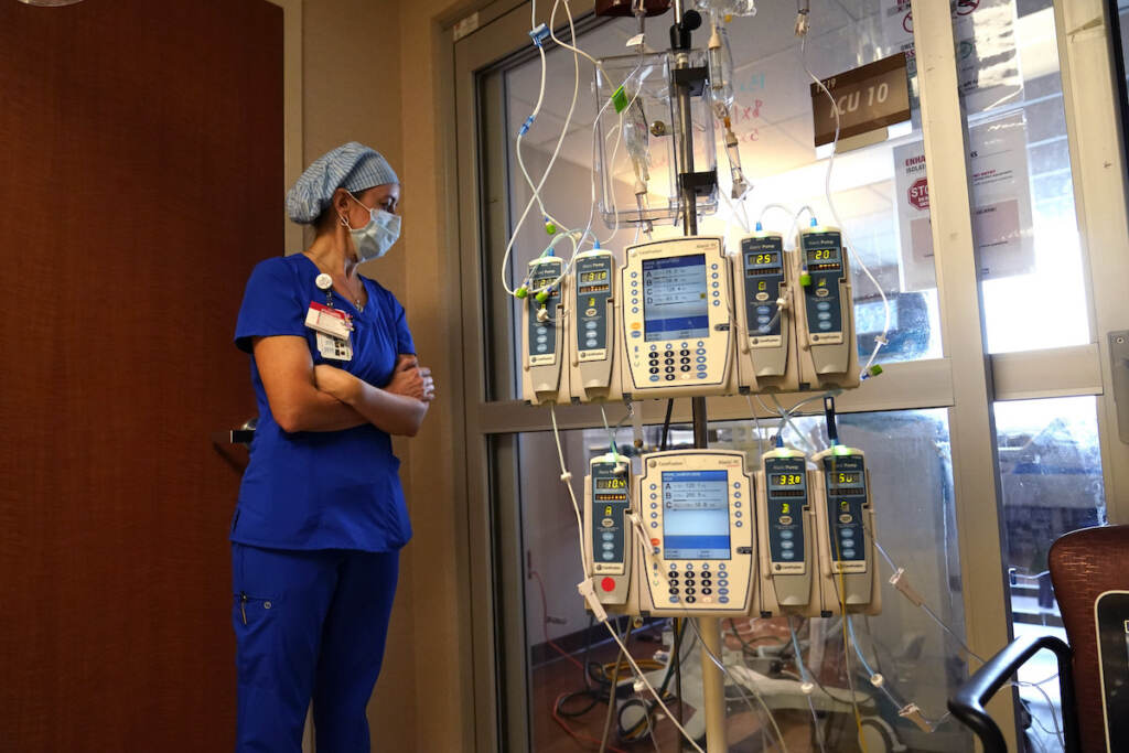 Virus Outbreak Beth Springer looks into a patient's room