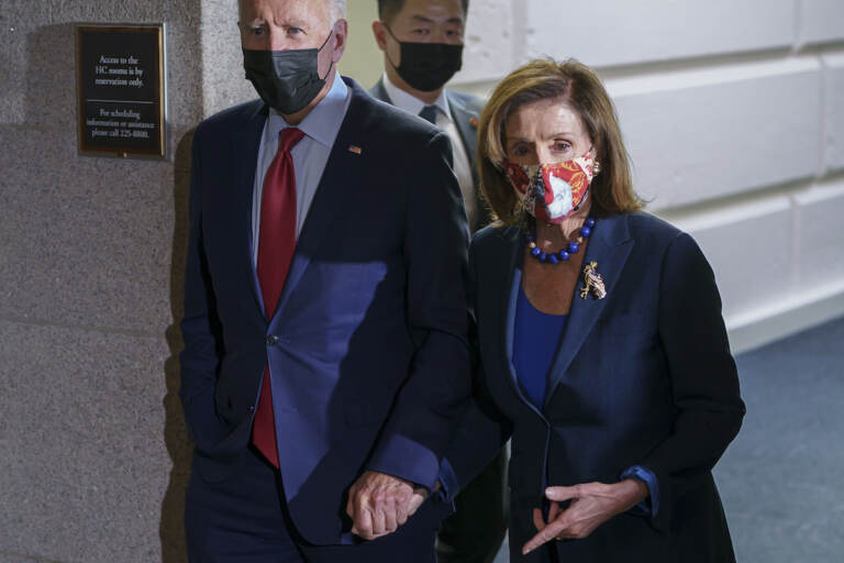 President Joe Biden and Speaker of the House Nancy Pelosi, D-Calif., talk in a basement hallway of the Capitol after meeting with House Democrats to rescue his his $3.5 trillion government overhaul and salvage a related public works bill, in Washington, Friday, Oct. 1, 2021
