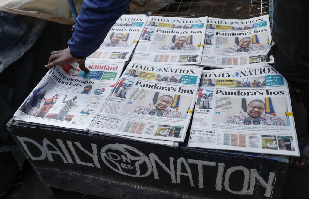 Kenyans read the morning newspapers reporting a statement issued by President Uhuru Kenyatta following reports that he is among more than 330 current and former politicians identified as beneficiaries of secret financial accounts, in the low-income Kibera neighborhood of Nairobi, Kenya Tuesday, Oct. 5, 2021