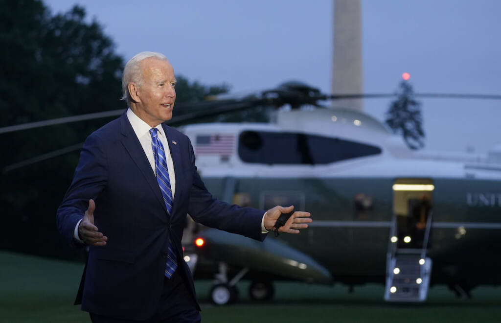Biden President Joe Biden talks with reporters after returning to the White House in Washington, Tuesday, Oct. 5, 2021, after a trip to Michigan to promote his infrastructure plan