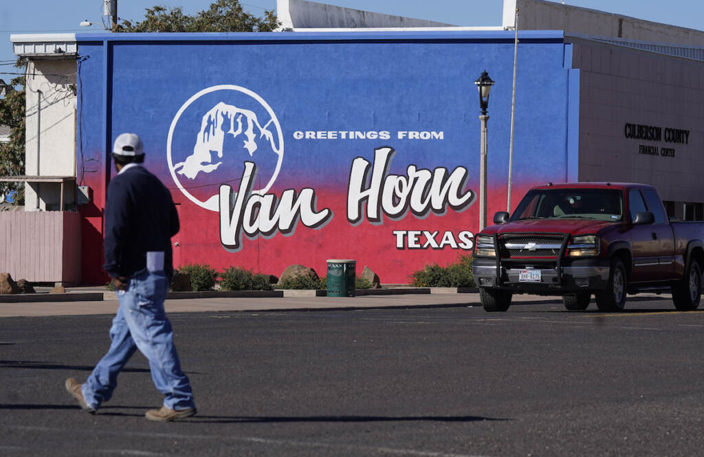 A pedestrian crosses the street in Van Horn, Texas, Monday, Oct. 11, 2021.