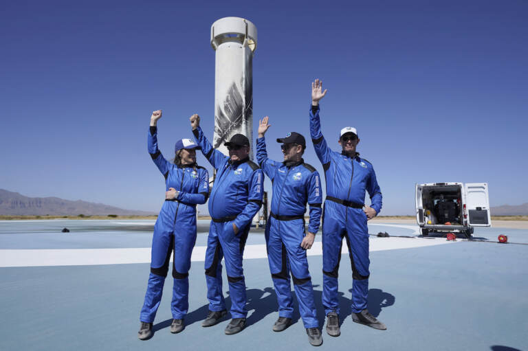Blue Origin's New Shepard rocket latest space passengers from left, Audrey Powers, William Shatner, Chris Boshuizen, and Glen de Vries raise their hands during a media availability at the spaceport near Van Horn, Texas, Wednesday, Oct. 13, 2021