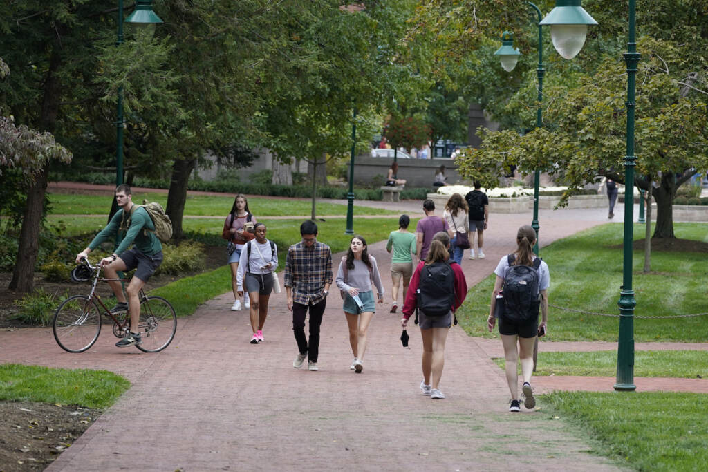 2020 Census College Towns Students walk to and from classes on the Indiana University campus, Thursday, Oct. 14, 2021, in Bloomington, Ind. College communities such as Bloomington are exploring their options for contesting the results of the 2020 census, which they say do not accurately reflect how many people live there. (AP Photo/Darron Cummings)