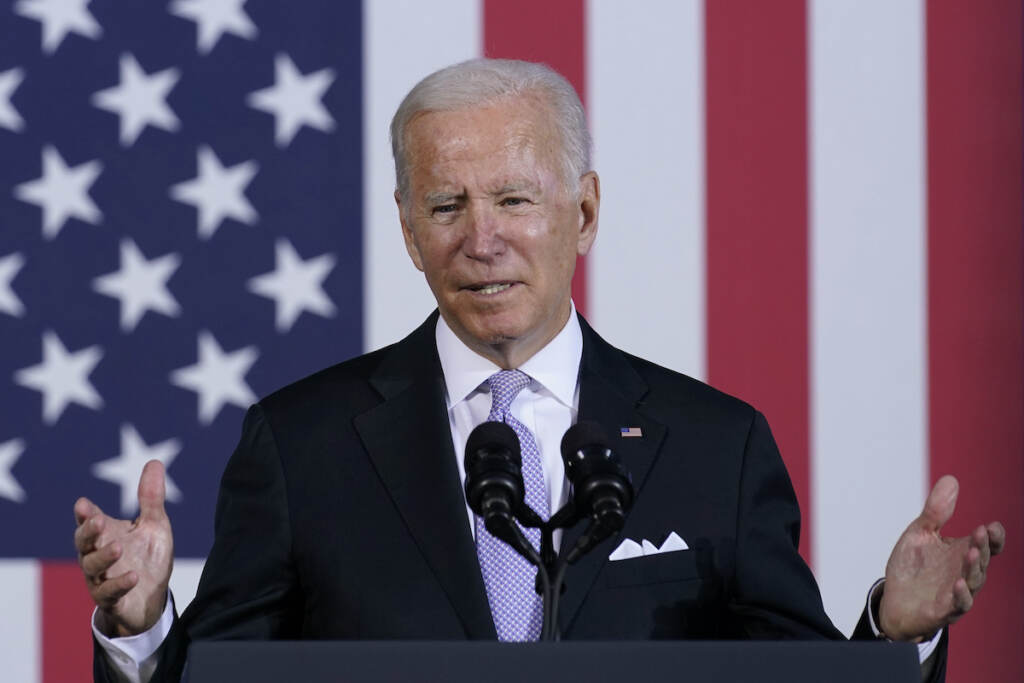 Joe Biden President Joe Biden speaks in front of an American flag backdrop
