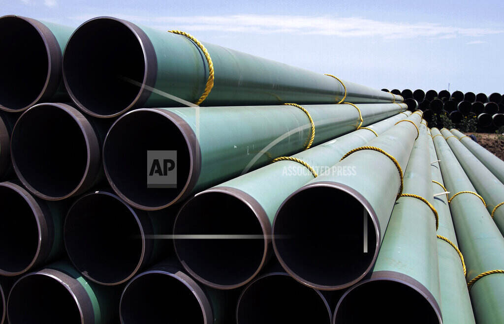 Natural Gas Promises In this May 15, 2011 photo, hundreds of drilling pipes are stacked at a rail center in Gardendale, Texas. (AP Photo/Pat Sullivan, File)