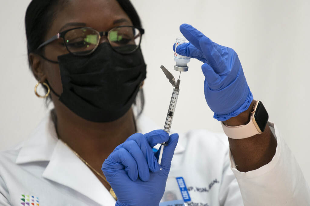 Virus Outbreak Michelle Chester prepares a vial of the Moderna COVID-19