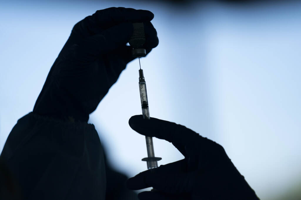 Virus Outbreak Hands are pictured preparing a COVID-19 vaccine