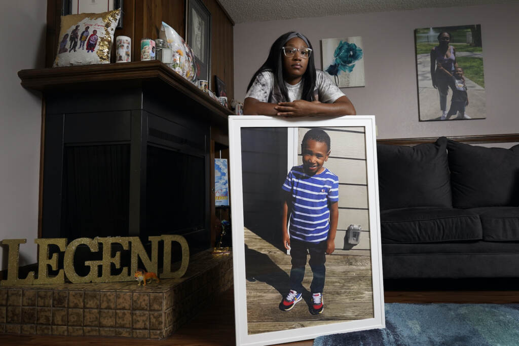 Charron Powell Charron Powell stands with a photo of her son, LeGend Talieferro, at her home