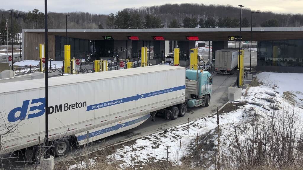 Virus Outbreak US Borders Truck traffic from Canada waits to cross the border