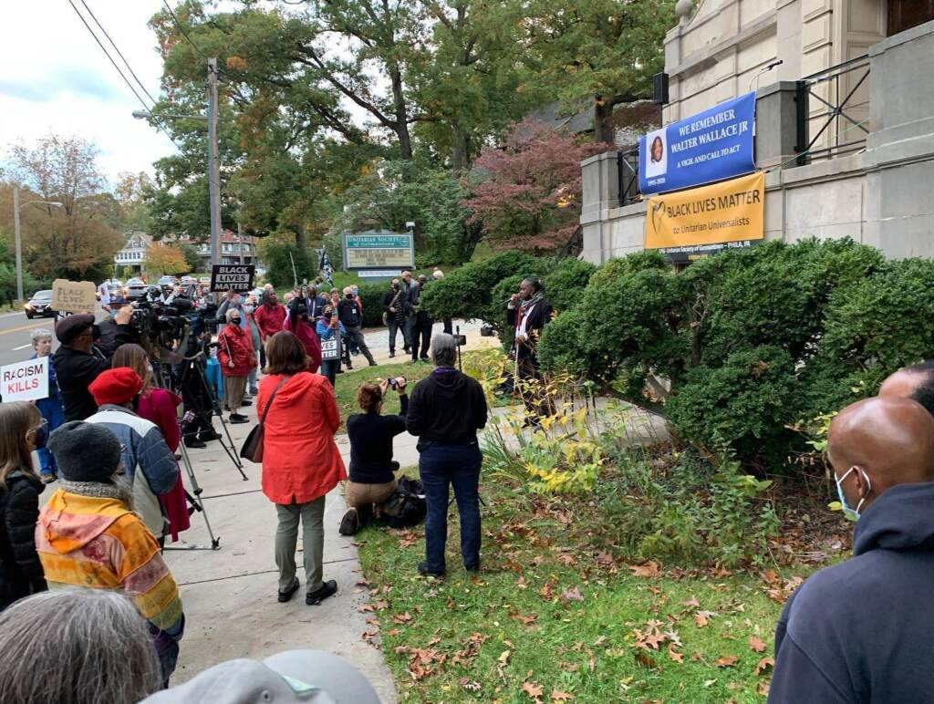 A crowd gathers around speaker Melanie DuBose at a vigil for Walter Wallace Jr. in Germantown on Oct. 27, 2021