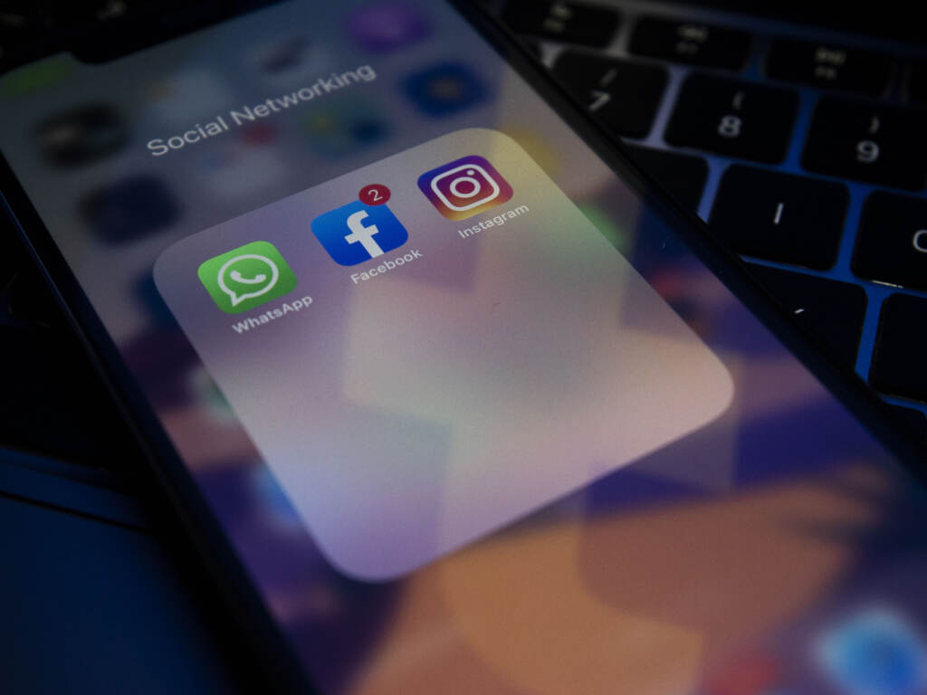 A photo illustration shows social media apps Instagram, Facebook and WhatsApp on a phone screen. Facebook says its worldwide services were taken offline by a problem with its servers. A photo illustration shows social media apps Instagram, Facebook, and WhatsApp on a phone screen