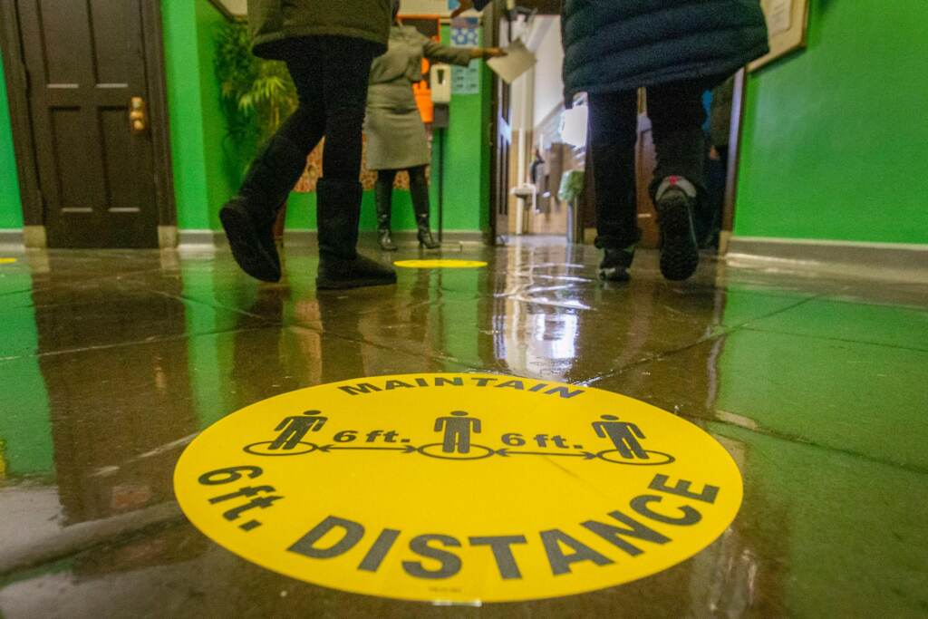PA_schools_social_distancing_100721 A marker on the floor of a school hallway reminds students to physically distance.