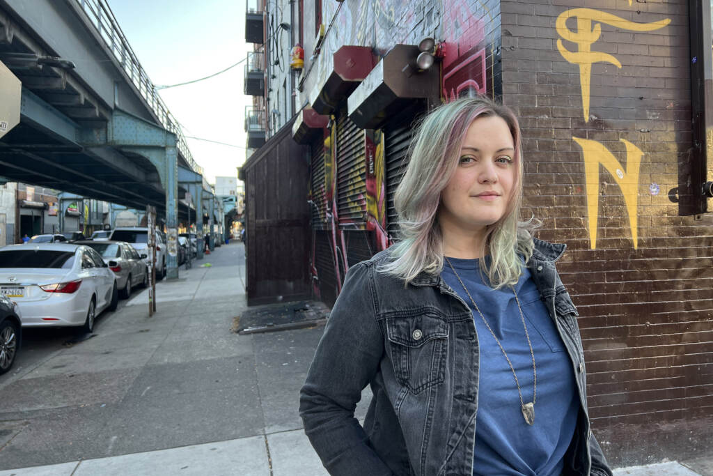 Amy Hartranft stands under the El in Philadelphia