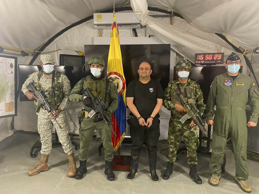 In this photo released by the Colombian presidential press office, one of the country’s most wanted drug traffickers, Dairo Antonio Usuga, alias “Otoniel,” leader of the violent Clan del Golfo cartel, is presented to the media at a military base in Necocli, Colombia, Saturday, Oct. 23. In this photo released by the Colombian presidential press office, one of the country’s most wanted drug traffickers, Dairo Antonio Usuga, alias “Otoniel,” leader of the violent Clan del Golfo cartel, is presented to the media at a military base in Necocli, Colombia, Saturday, Oct. 23, 2021. (Colombian presidential press office via AP)