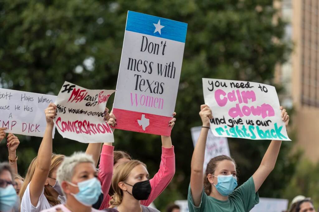 ap_21275682594692_slide-010280660378b73b9e5fabb0f0cf6c093fb33967-s1600-c85 People take part in the Women's March ATX rally, Saturday, Oct., 2, 2021 in at the Texas State Capitol in Austin, Texas