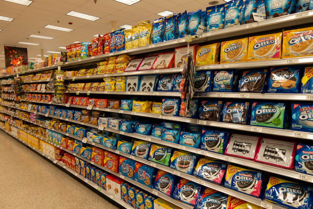 Vero Beach, Fl/usa – 8/2/19 – The Cookie Aisle In A Grocery Store With Two People Shopping. The cookie aisle in a grocery store with two people shopping.