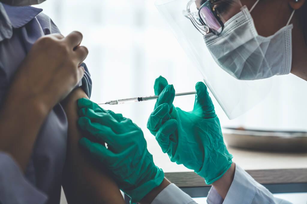 Young Woman Visits Skillful Doctor At Hospital For Vaccination . COVID-19 vaccine clinic. (World Image / BigStock)