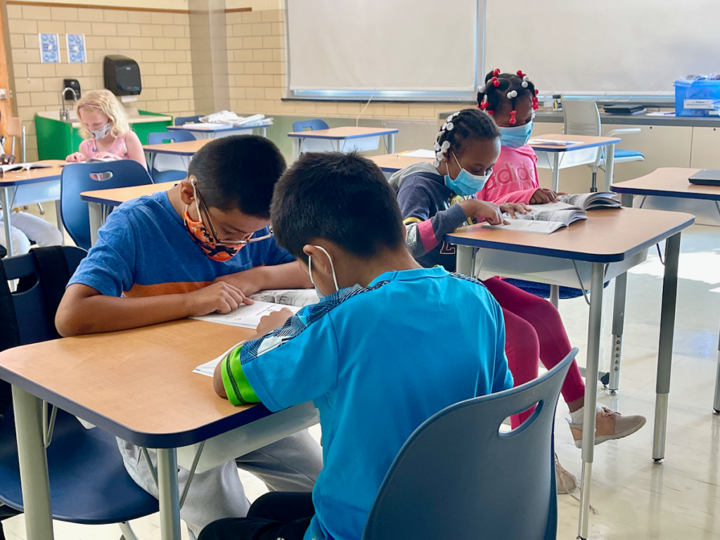 georgetown Kids sit at their desks in school