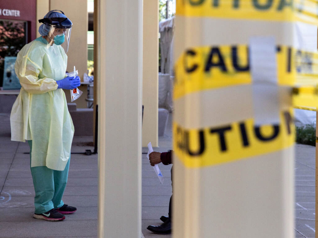 SAN PABLO, CA -  APRIL 24: Dr. Melina Beaton wears full personal protective equipment while administering a swab test on a patient at a walk-up coronavirus testing site at West County Health Center in San Pablo, Calif. Friday, April 24, 2020. California Governor Gavin Newsom says the state will need to test 60,000 to 80,000 each day in order to safely reopen society, with essential workers being tested more frequently than others. The state plans to open 86 new testing sites in 