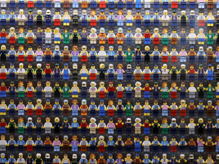 A wall of LEGO minifigures is encased inside the lobby of the LEGOLAND New York Hotel