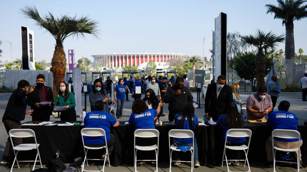 Los Angeles International Airport and SoFi Stadium employers spoke with potential job applicants at a job fair in Inglewood, Calif., in September. About 19% of all households in an NPR poll say they lost all their savings during the COVID-19 outbreak, and have none to fall back on. People receive information as they attend a job fair for employment with SoFi Stadium and Los Angeles International Airport employers, at SoFi Stadium on September 9, 2021, in Inglewood, California. - Fewer Americans made new claims for unemployment benefits last week than at any point since the Covid-19 pandemic began, according to government data released on September 9, the latest sign of progress in the job market following last year's mass layoffs. (Photo by Patrick T. FALLON / AFP) (Photo by PATRICK T. FALLON/AFP via Getty Images)