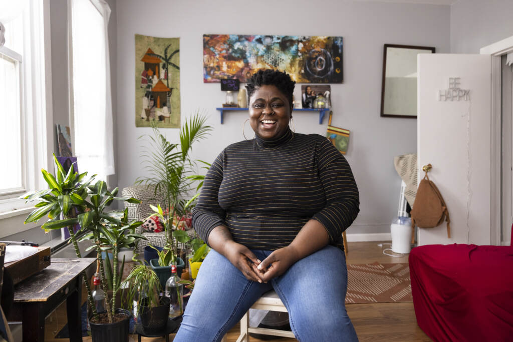 rc2021038_0133 Iresha Picot sits on a stool in her home