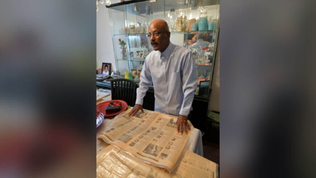 2021-11-09-robert-davis-philadelphia-tribune Robert Davis of West Oak Lane looks at his collection of newspapers that chronicled the loss of lives of Vietnam War troops who were Edison High School students. (Abdul R. Sulayman / The Philadelphia Tribune)