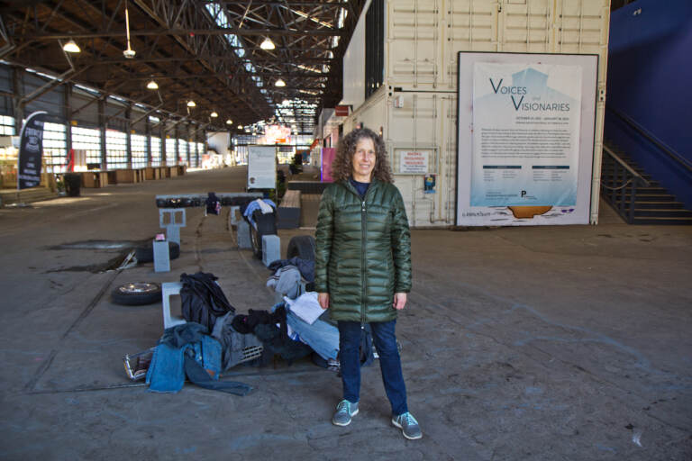 Leslie Kaufman, curator or Voices and Visions, a sculpture show at Cherry Street Pier in Philadelphia, stands by a piece that was damaged in flooding the last week of October, 2021