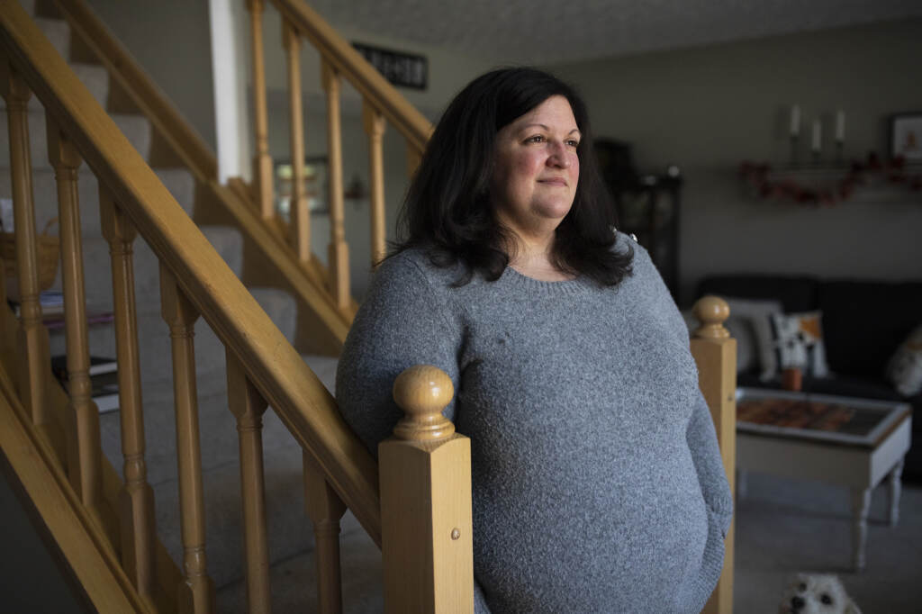 Lauren Barber stands in her home in Columbus, Ohio, on Nov. 16. Barber has been inundated with offers from investors and companies that want to buy her house. She sometimes gets called or texted more than five times a day with offers. Lauren Barber stands in her home in Columbus, Ohio, on Nov. 16. Barber has been inundated with offers from investors and companies that want to buy her house. She sometimes gets called or texted more than five times a day with offers.
(Maddie McGarvey / NPR)