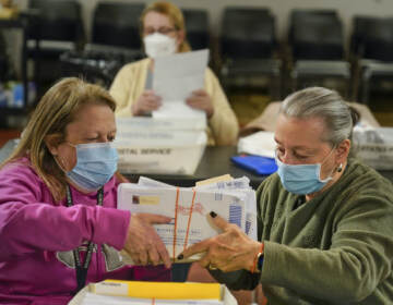 Bernadette Witt, left, and JoAnn Bartlett, right, process and double-check mail ballots