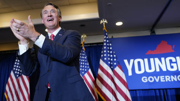 Virginia Gov.-elect Glenn Youngkin claps while on stage