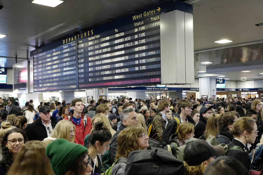 Thanksgiving Travel Passengers stand beneath an electronic signboard in New York's Penn Station as they wait to board a train, Sunday, Nov. 27, 2016. Millions of Americans are returning home Sundy after the long Thanksgiving weekend. (AP Photo/Mark Lennihan)
