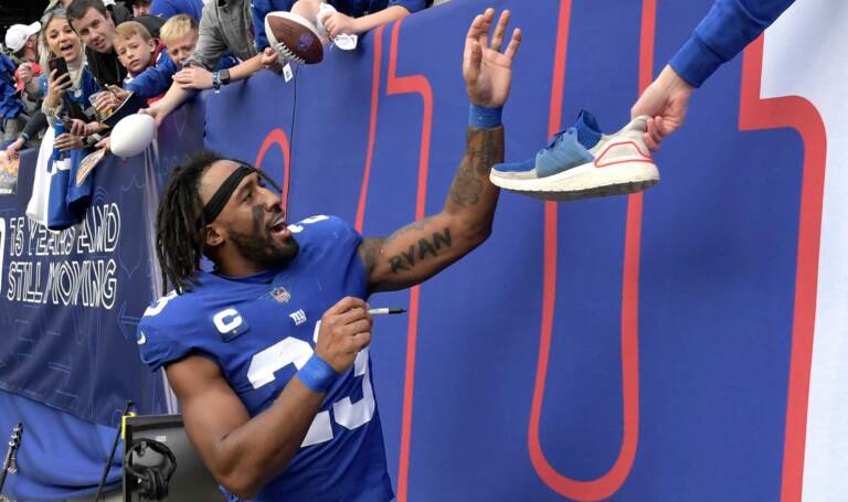 New York Giants safety Logan Ryan (23) signs autographs as he walks off the field after the Giants defeated the Carolina Panthers 25-3 in an NFL football game Sunday, Oct. 24, 2021, in East Rutherford, N.J.
