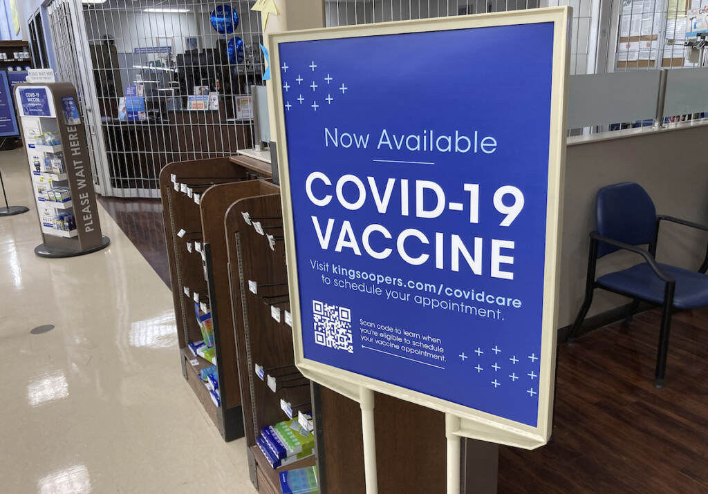Virus Outbreak-Vaccine Mandates A sign notifies customers that COVID-19 vaccinations are available at a pharmacy in a grocery store