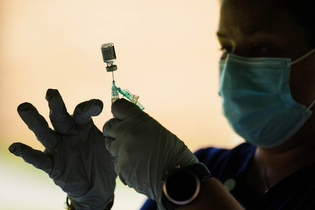 Virus Outbreak Boosters A syringe is prepared with the Pfizer COVID-19 vaccine at a clinic at the Reading Area Community College in Reading, Pa., Tuesday, Sept. 14, 2021. (AP Photo/Matt Rourke)