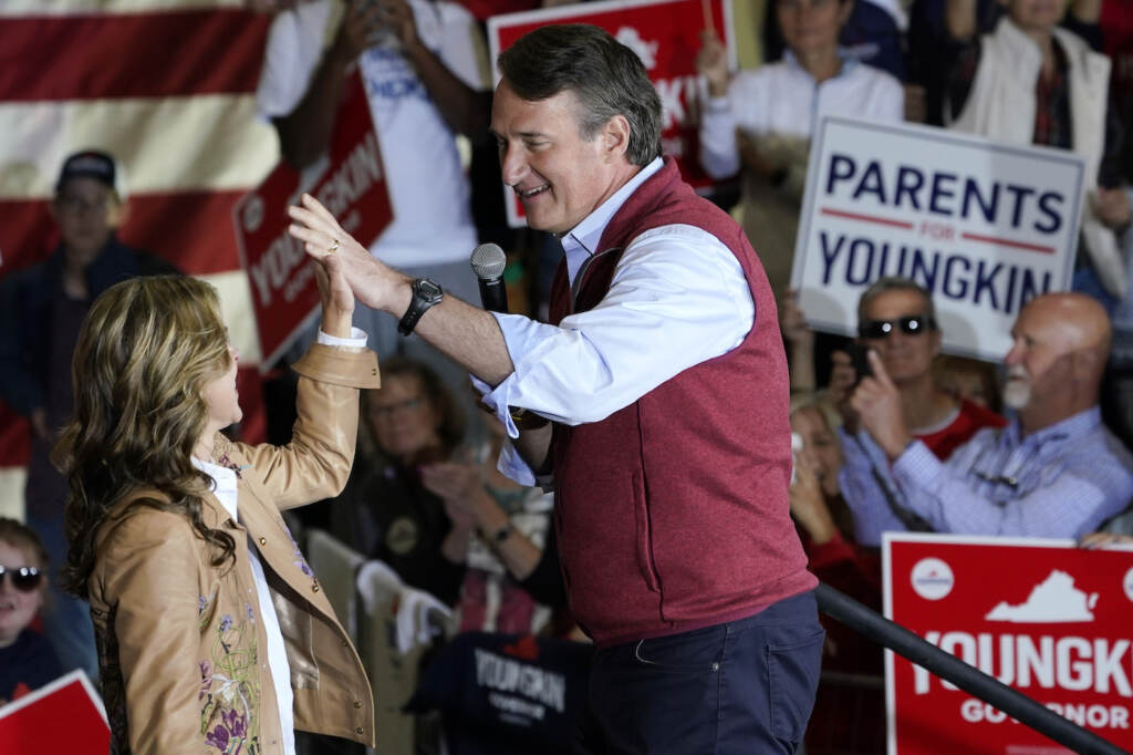 Glenn Youngkin, Suzanne Youngkin Republican gubernatorial candidate Glenn Youngkin, right, gives his wife Suzanne, a high five during a rally in Chesterfield, Va., Monday, Nov. 1, 2021