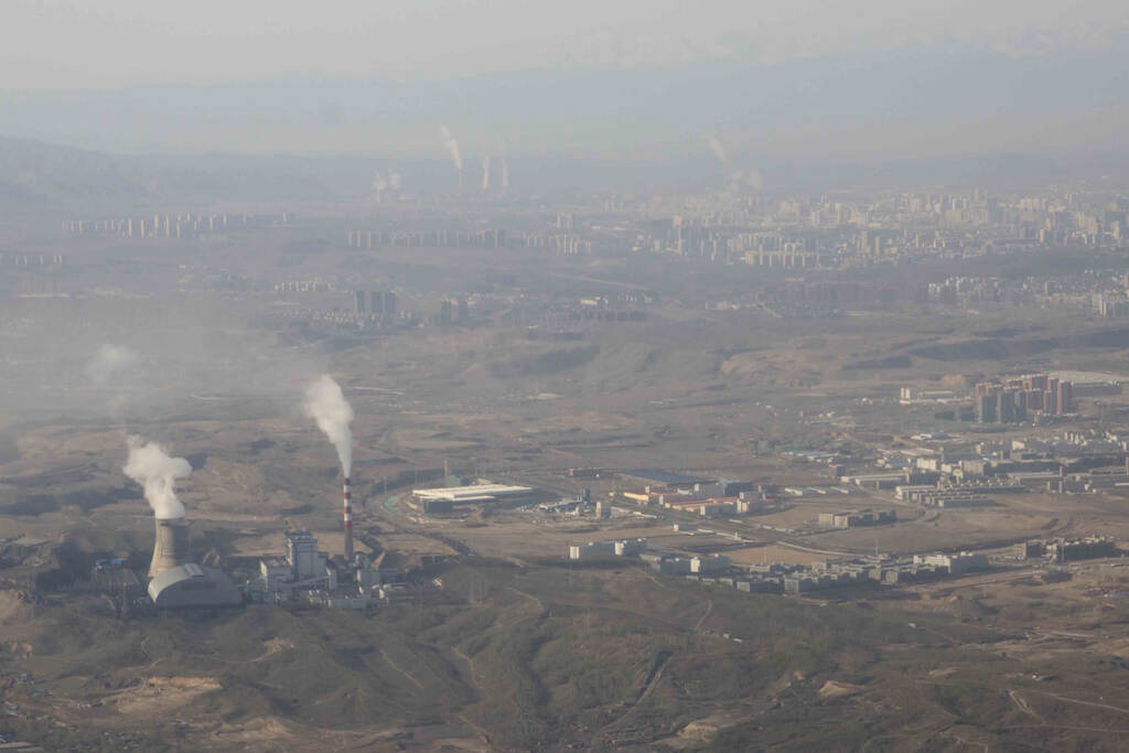 Climate COP26 Emissions Smoke and steam rise from towers at the coal-fired Urumqi Thermal Power Plant in Urumqi in western China’s Xinjiang Uyghur Autonomous Region, Wednesday, April 21, 2021. China, the world's biggest coal user, said Tuesday the fossil fuel will play a less dominant role in its energy mix and that, despite plans to build new coal-fired power plants, the country won't use it on a wide scale