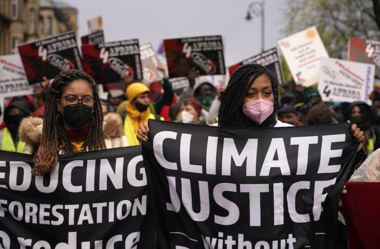 Climate activists hold up banners during a protest organized by the Cop26 Coalition in Glasgow, Scotland, Saturday, Nov. 6, 2021 which is the host city of the COP26 U.N. Climate Summit. The protest was taking place as leaders and activists from around the world were gathering in Scotland's biggest city for the U.N. climate summit, to lay out their vision for addressing the common challenge of global warming