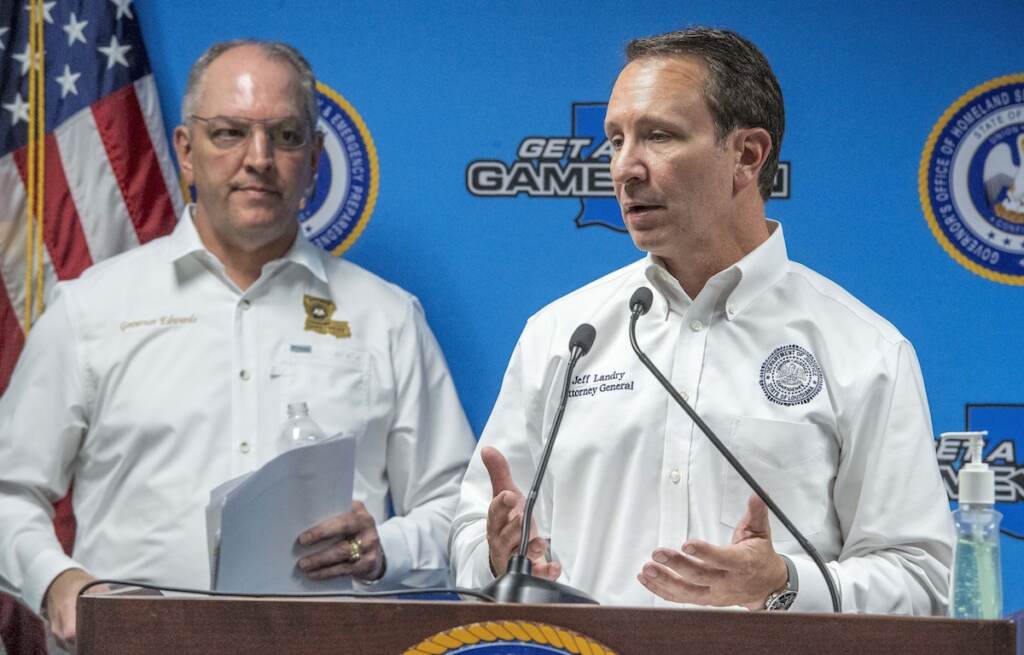 File Photo: Louisiana Gov. John Bel Edwards, left, listens as Attorney General Jeff Landry, right, speaks about medicines being donated by drug companies to help the fight against COVID-19 at the Governor's Office of Homeland Security & Emergency Management, April 6, 2020, in Baton Rouge, La. A federal appeals court has temporarily halted the Biden administration’s vaccine requirement for businesses with 100 or more workers. The 5th U.S. Circuit Court of Appeals on Saturday, Nov. 6, 2021, granted an emergency stay of the requirement by the federal Occupational Safety and Health Administration that those workers be vaccinated by Jan. 4, or face mask requirements and weekly tests. Landry said the court action halts President Biden’s administration from “moving forward with his unlawful overreach.”