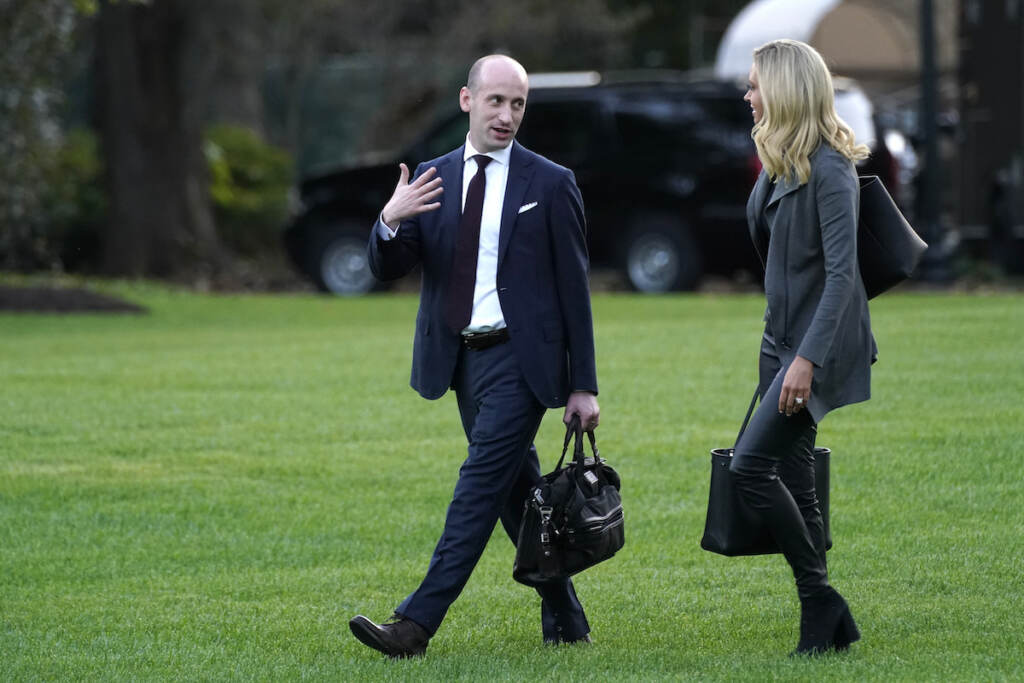 Kayleigh McEnany and White House senior adviser Stephen Miller walk across the South Lawn
