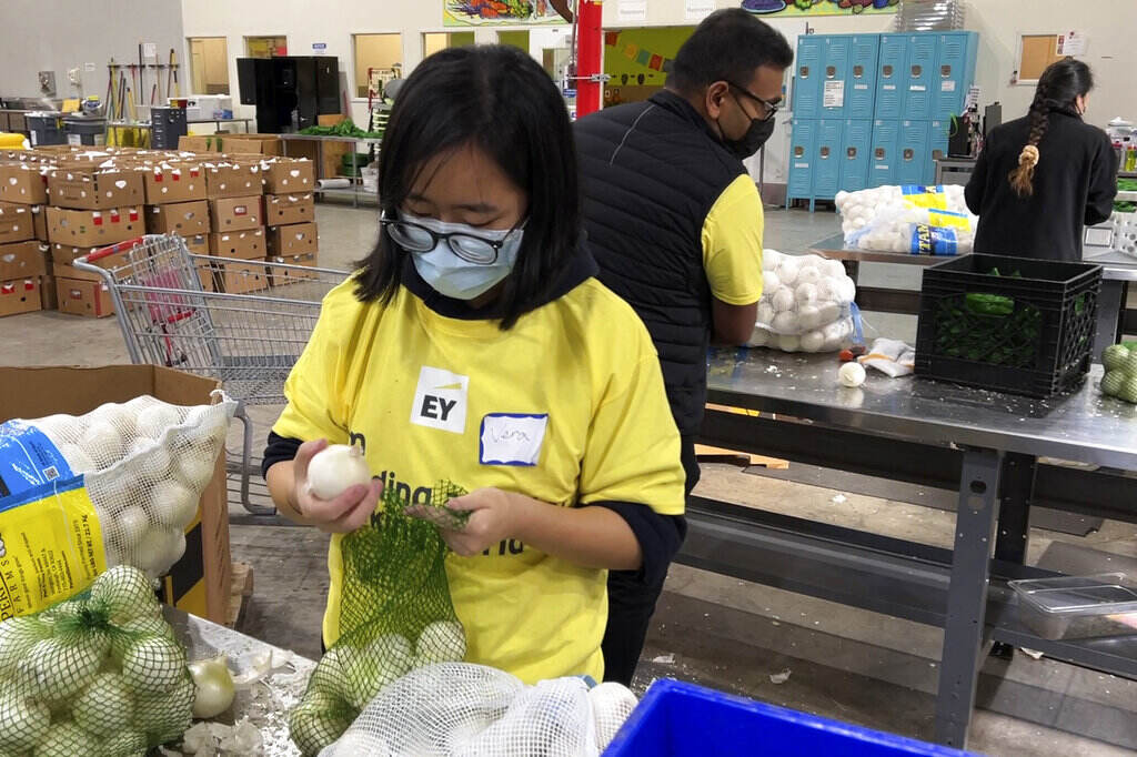 Hunger in America Rising Prices Workers pack onions at a food bank.