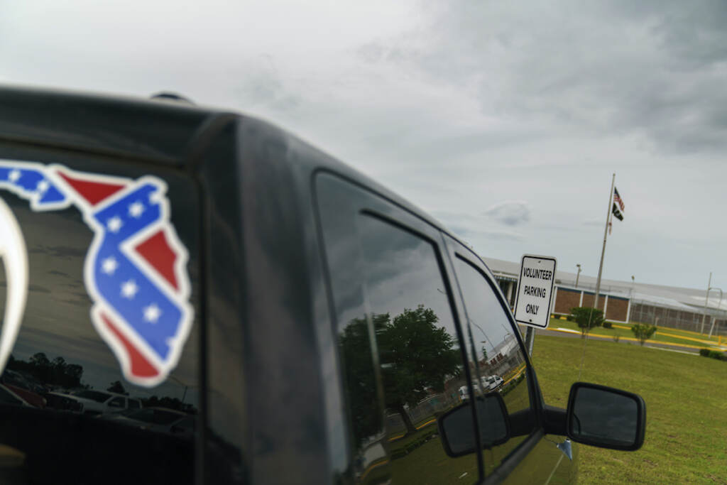 White Supremacists Law Enforcement A pickup truck with a Confederate flag-themed decal is parked outside the Reception and Medical Center, the state's prison hospital where new inmates are processed, in Lake Butler, Fla., Friday, April 16, 2021. (AP Photo/David Goldman, File)