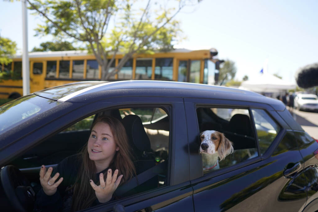Hunger in America Military Families Brooklyn Pittman talks as she sits in her car with her dogs after receiving food from an Armed Services YMCA food distribution, Oct. 28, 2021, in San Diego. As many of 160,000 active duty military members are having trouble feeding their families, according to Feeding America, which coordinates the work of more than 200 food banks around the country. (AP Photo/Gregory Bull)