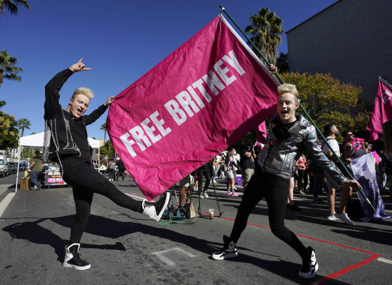 Twins Edward, right, and John Grimes of Dublin, Ireland, hold a 