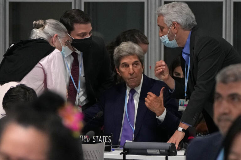 John Kerry, United States Special Presidential Envoy for Climate, center, confers during a stocktaking plenary session at the COP26 U.N. Climate Summit in Glasgow, Scotland, Saturday, Nov. 13, 2021. Going into overtime, negotiators at U.N. climate talks in Glasgow are still trying to find common ground on phasing out coal, when nations need to update their emission-cutting pledges and, especially, on money