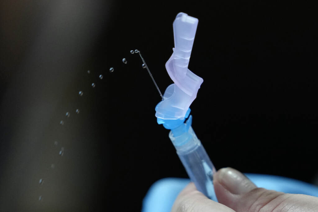 A health worker prepares PfizerÅfs COVID-19 vaccine at the National Kidney and Transplant Institute in Quezon city, Philippines on Wednesday, Nov. 17, 2021. TThe government has started inoculating booster shots to fully vaccinated frontline workers as it eases health restrictions while active COVID-19 cases continue to decline in the country