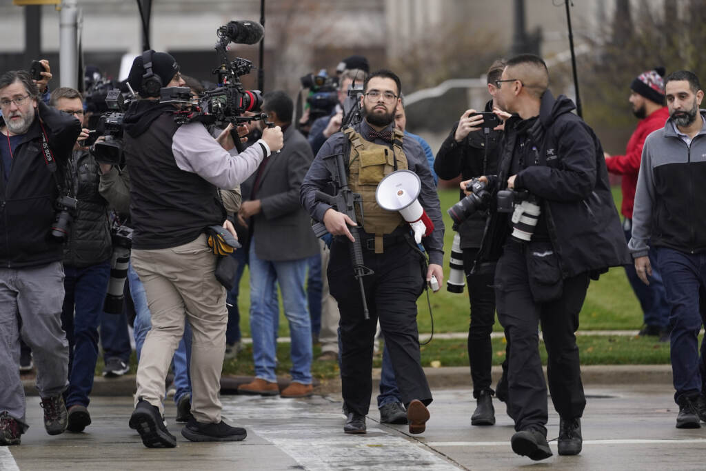 APTOPIX Kenosha Protest Shootings A protester carrying a rifle leaves the the Kenosha County Courthouse after speaking with Kenosha County Sheriffs Department officers, Wednesday, Nov. 17, 2021 in Kenosha, Wis., during the Kyle Rittenhouse murder trial. Rittenhouse is accused of killing two people and wounding a third during a protest over police brutality in Kenosha, last year. (AP Photo/Paul Sancya)