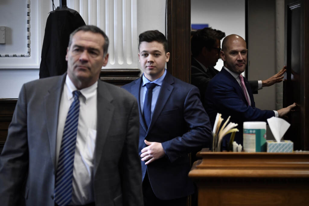 Kenosha Protest Shootings Kyle Rittenhouse, center, enters the courtroom with his attorneys Mark Richards, left, and Corey Chirafisi for a meeting called by Judge Bruce Schroeder at the Kenosha County Courthouse in Kenosha, Wis., on Thursday, Nov. 18, 2021. (Sean Krajacic/The Kenosha News via AP, Pool)
